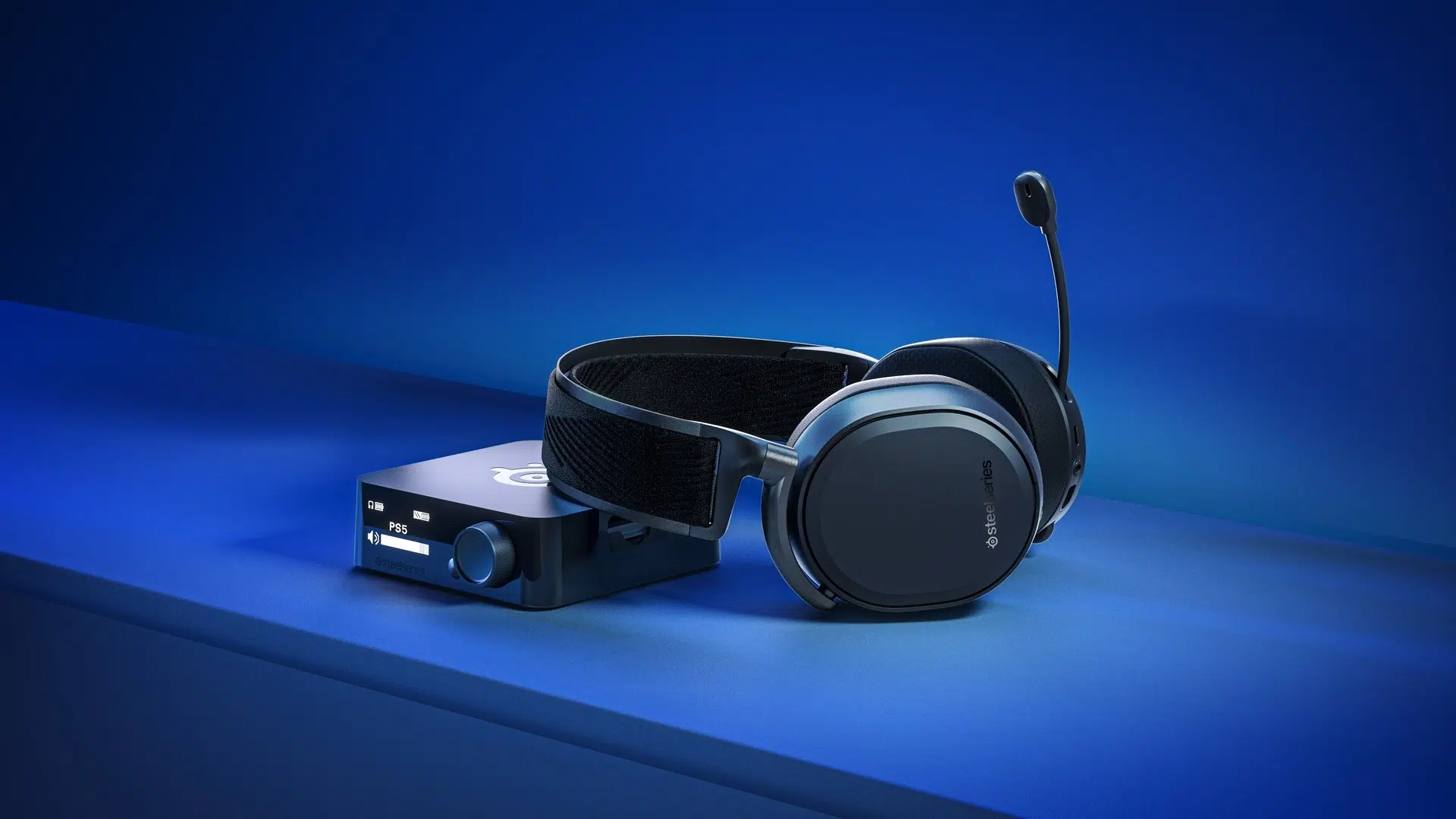 SteelSeries Arctis Pro Wireless black headset with transmitter on a desk