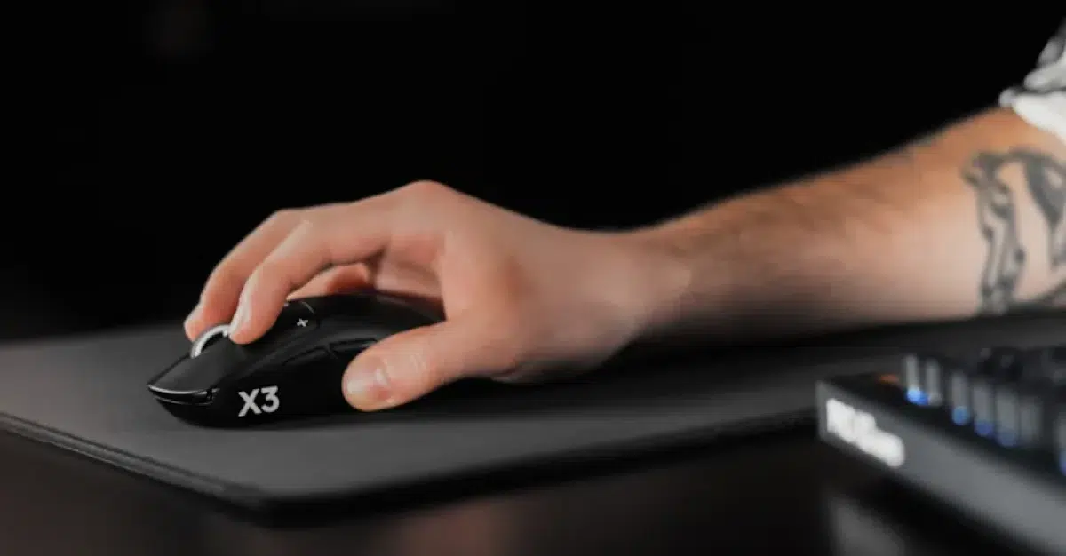 Player using the Logitech G PRO X3 SUPERSTRIKE mouse on a gaming mousepad