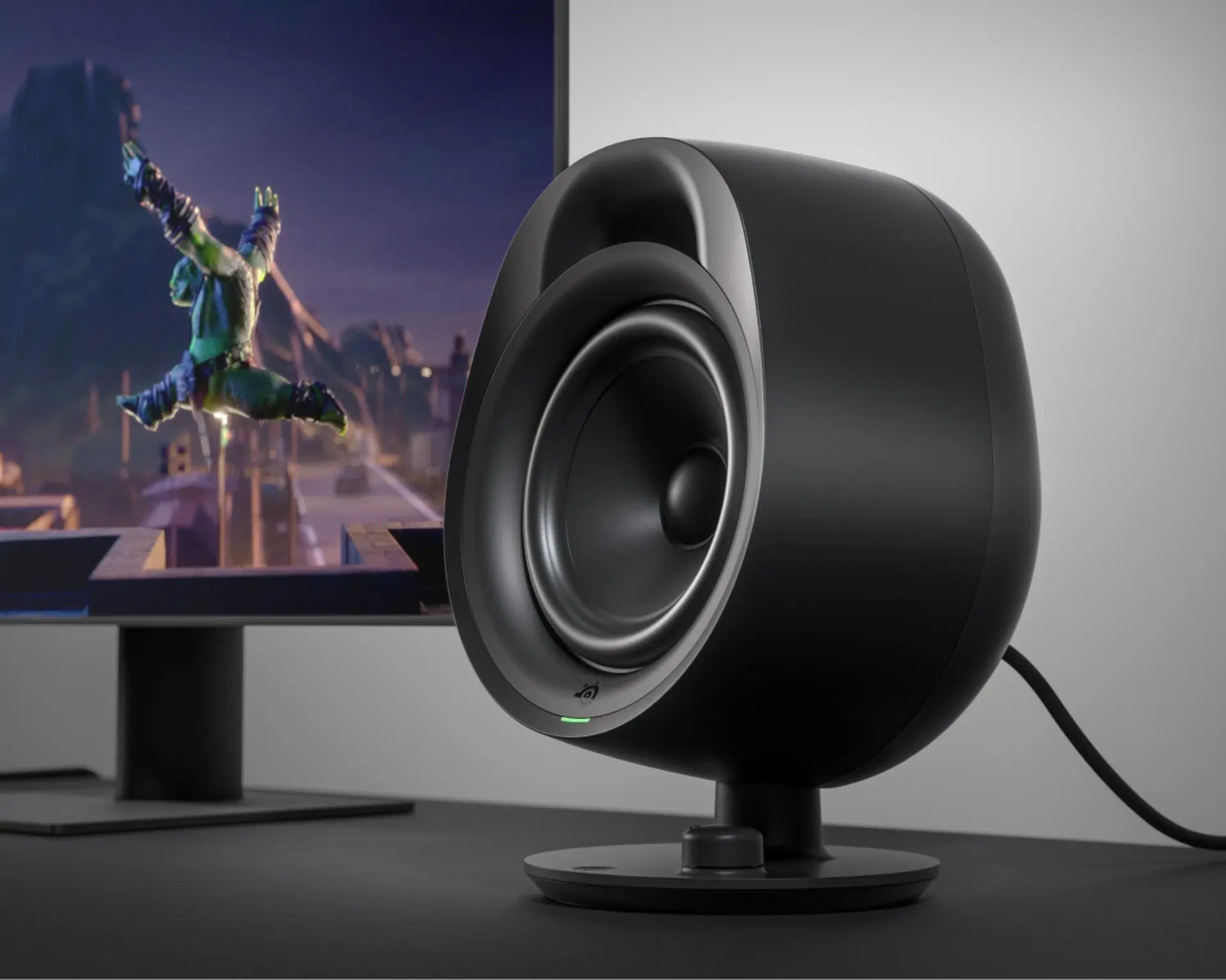 SteelSeries Arena 3 speaker beside a gaming monitor