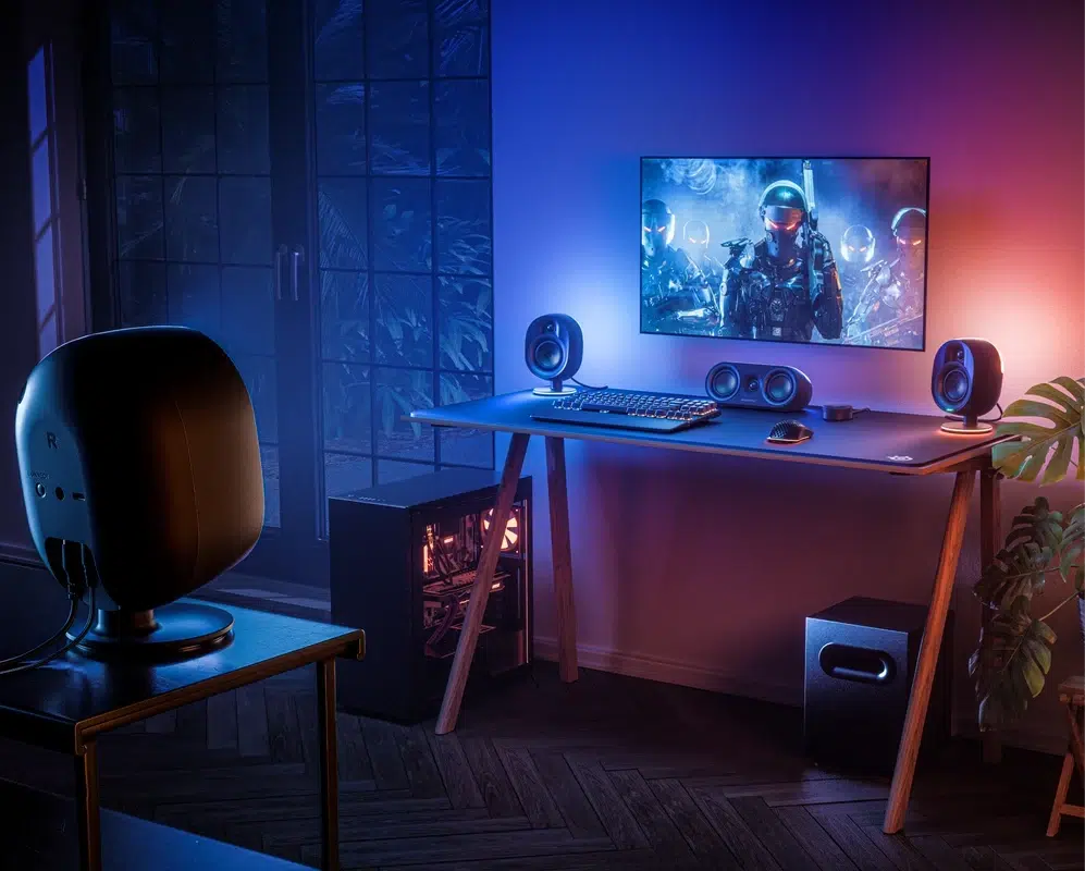 SteelSeries Arena 9 surround speakers positioned around a gaming desk